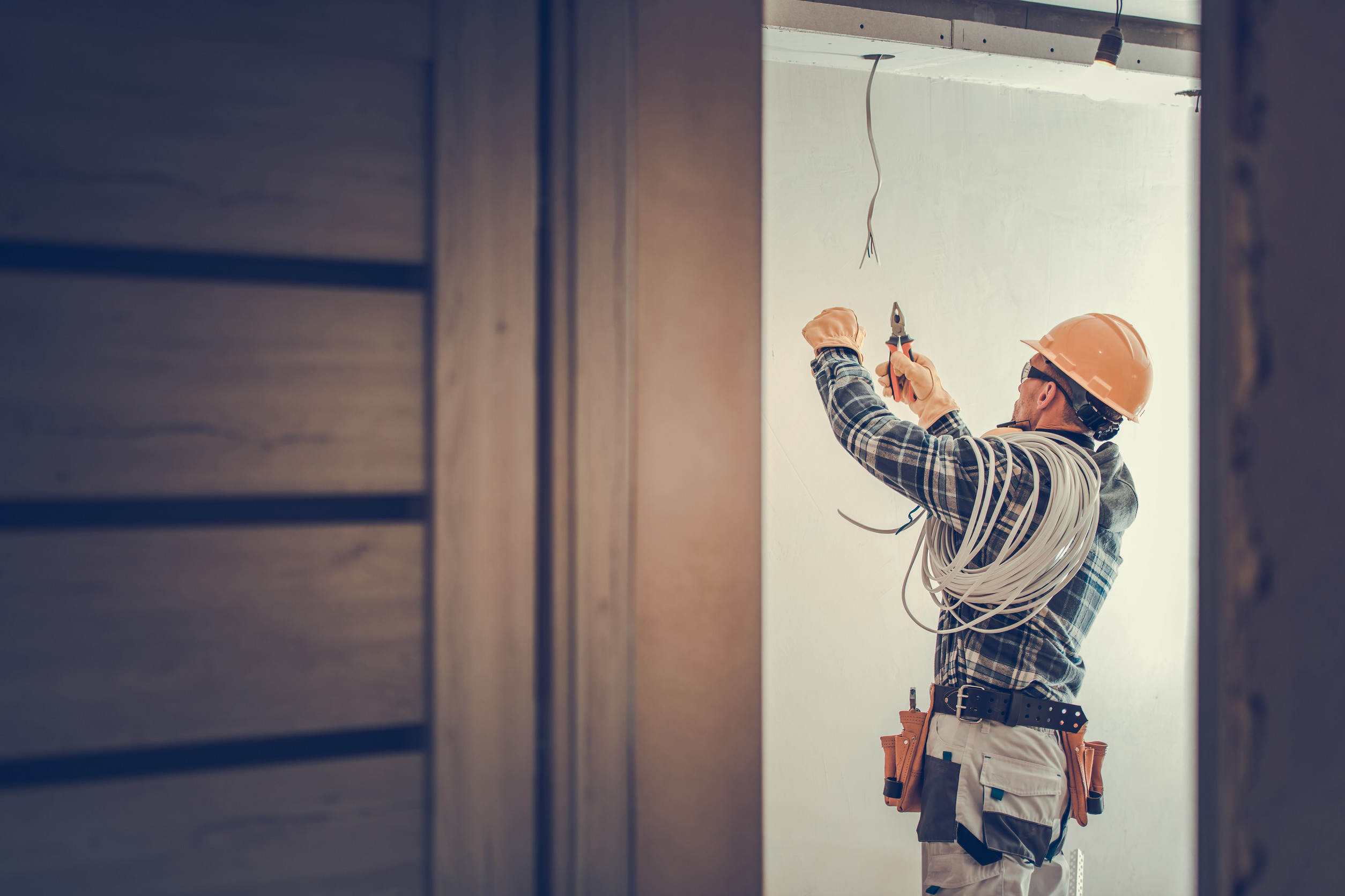 Electrician installing wiring in a building